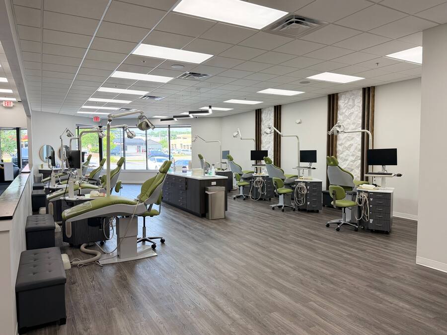 Open orthodontic treatment bay with green chairs at the Greenfield office