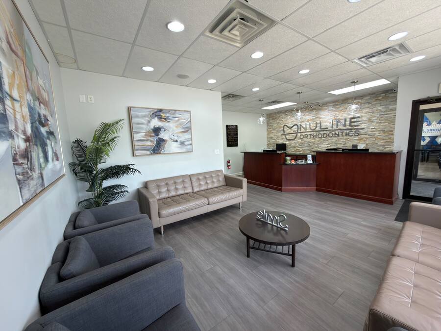 NuLine Orthodontics signage on the stone feature wall behind the Milwaukee reception desk