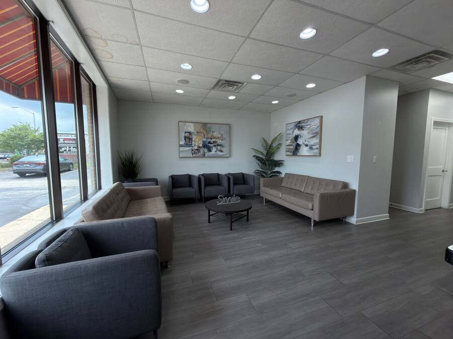 Waiting lounge with sofas and street-facing windows at the Milwaukee office