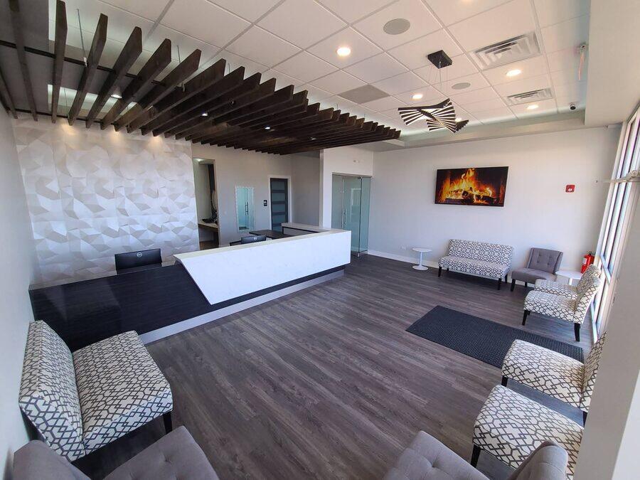 Reception desk and wood-slat ceiling feature in the Roscoe office lobby