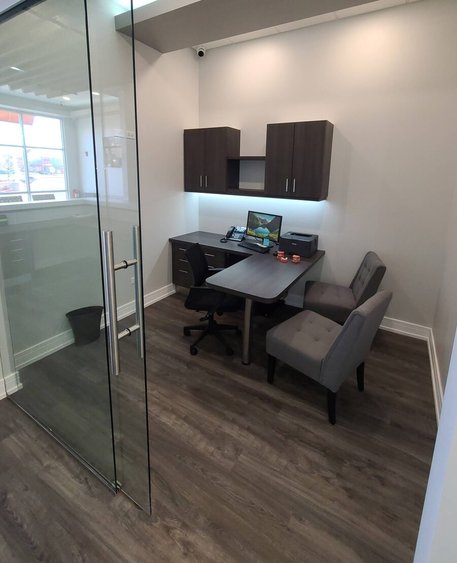 Private consultation office with a desk and seating at the Roscoe office