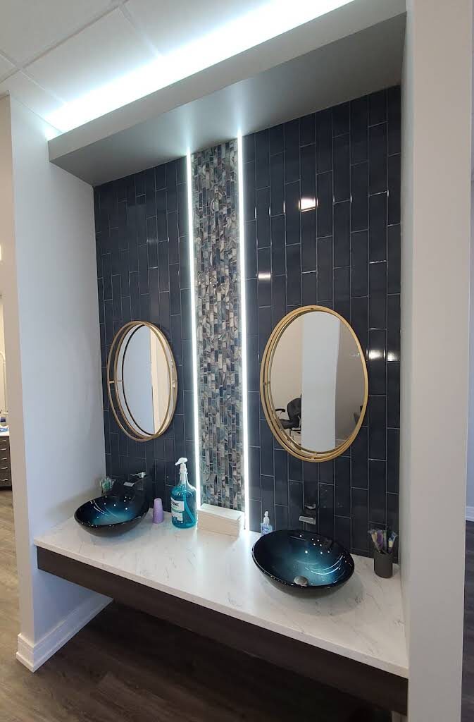 Patient hand-washing station with a tiled feature wall at the Roscoe office