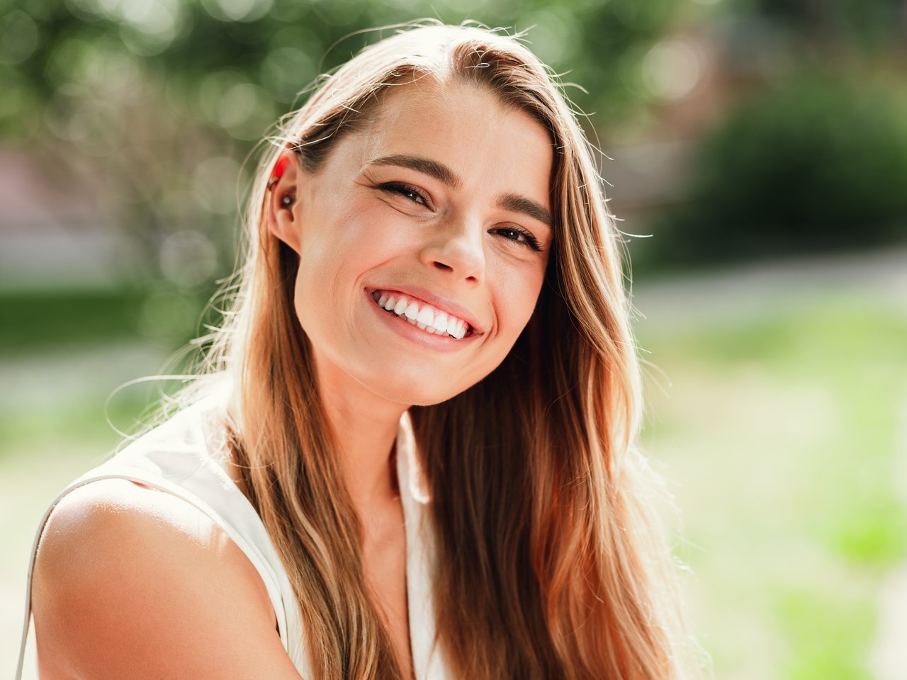 Patient smiling after orthodontic treatment at NuLine Orthodontics in Roscoe, IL